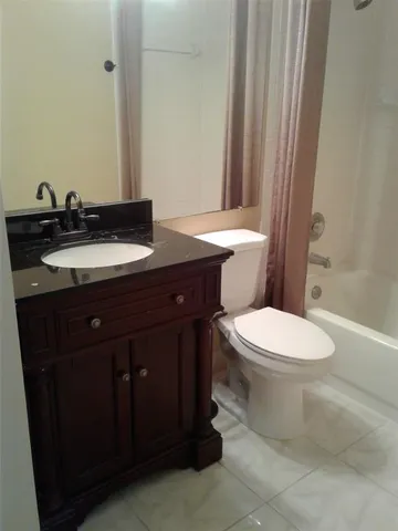a bathroom with a toilet a sink and a mirror