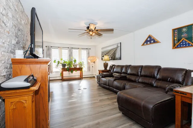 a living room with furniture and a chandelier