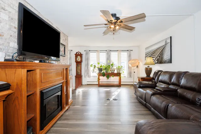 a living room with fireplace furniture and a flat screen tv