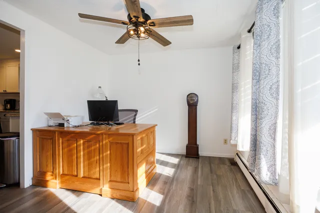 a dining room with furniture and wooden floor