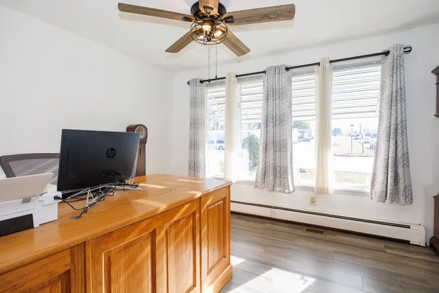 a workspace with chandelier and window