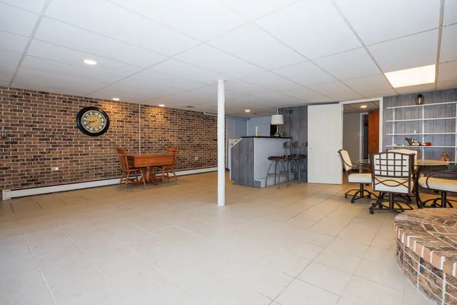 a view of a livingroom with furniture and a window