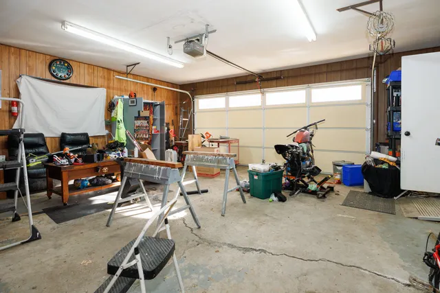 a room with gym equipment and a view of kitchen appliances