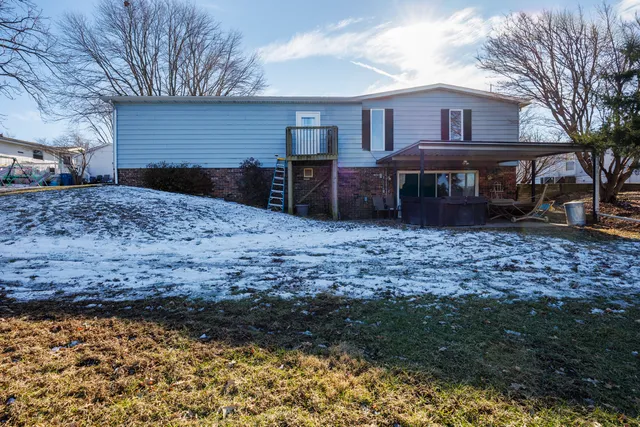 a room with pool table and windows