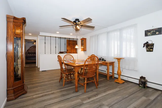 a view of a dining room with furniture and wooden floor
