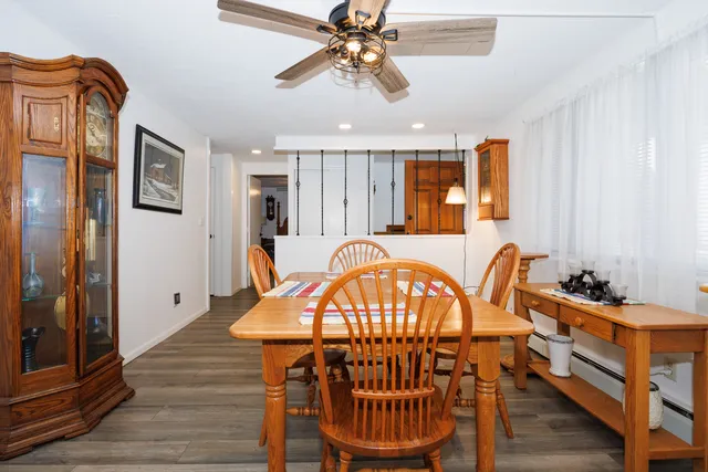 a view of a a dining room with furniture window and wooden floor