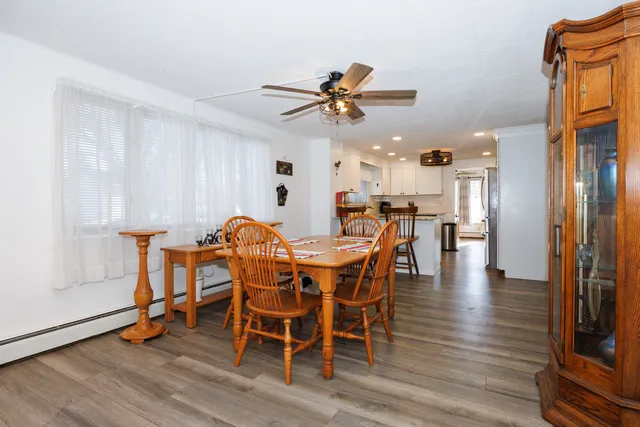 a view of a dining room with furniture and wooden floor