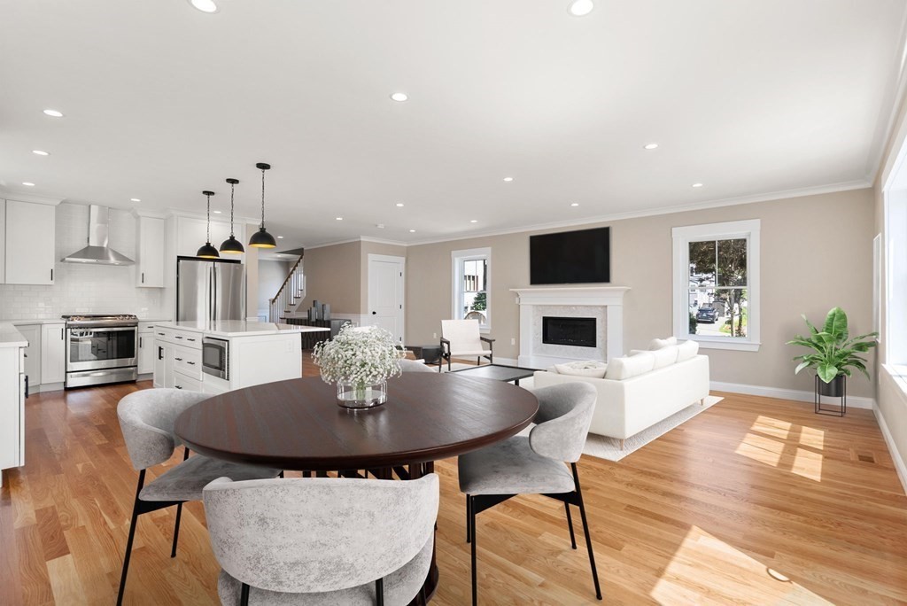 a living room with fireplace furniture dining table and a fireplace
