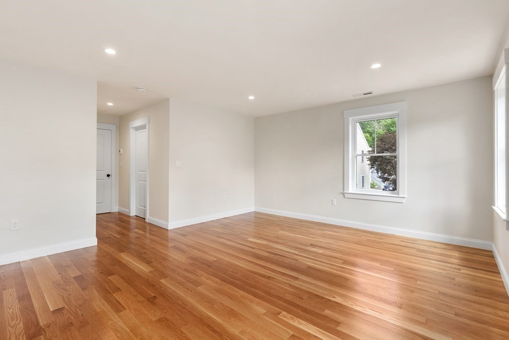 38 Gregory Street Waltham, MA 02451 - Photo 13 of 21 a view of an empty room with wooden floor and a window