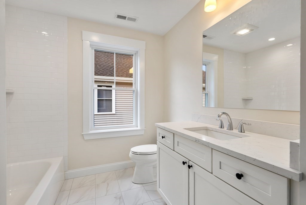 38 Gregory Street Waltham, MA 02451 - Photo 14 of 21 a bathroom with a toilet sink and mirror