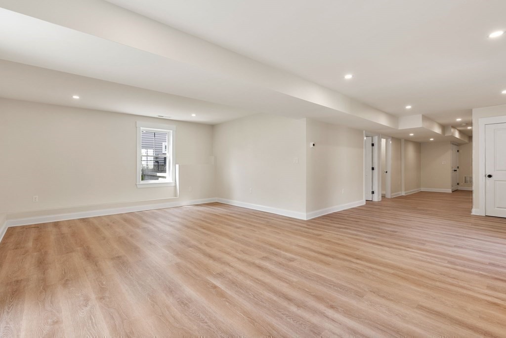 38 Gregory Street Waltham, MA 02451 - Photo 16 of 21 an empty room with wooden floor and windows