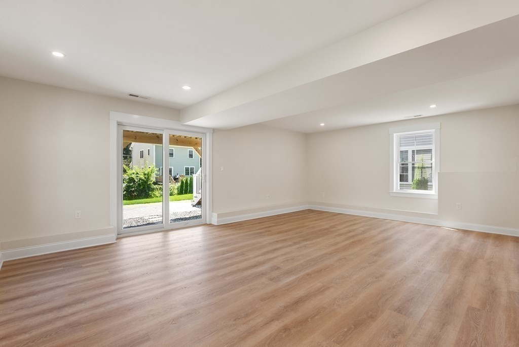 38 Gregory Street Waltham, MA 02451 - Photo 17 of 21 a view of an empty room with wooden floor and a window
