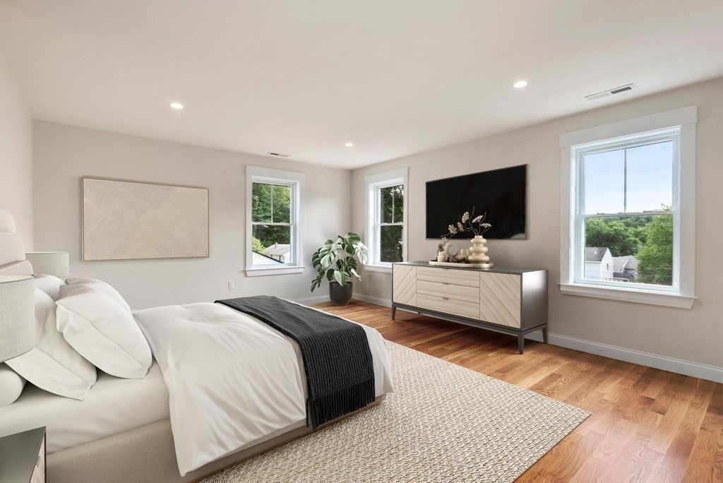 38 Gregory Street Waltham, MA 02451 - Photo 4 of 21 a bedroom with a bed wooden floor and window