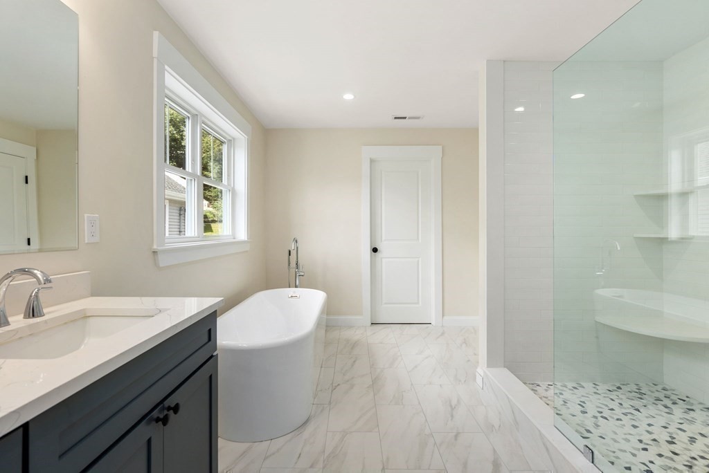 38 Gregory Street Waltham, MA 02451 - Photo 5 of 21 a bathroom with a sink a toilet and shower