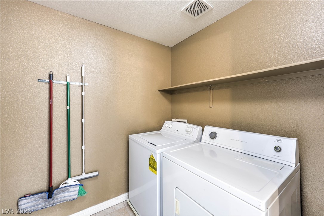 9050 West Warm Springs Road, Unit 2033 Las Vegas, NV 89148 - Photo 23 of 30 Functional utility space with convenient wall-mounted storage and upper shelving for household essentials.