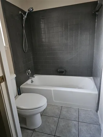 a bathroom with a toilet and a bathtub