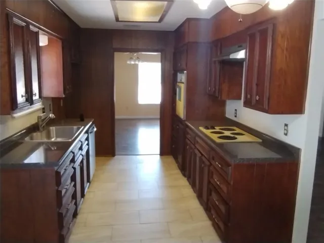 a kitchen with stainless steel appliances granite countertop a stove and a refrigerator
