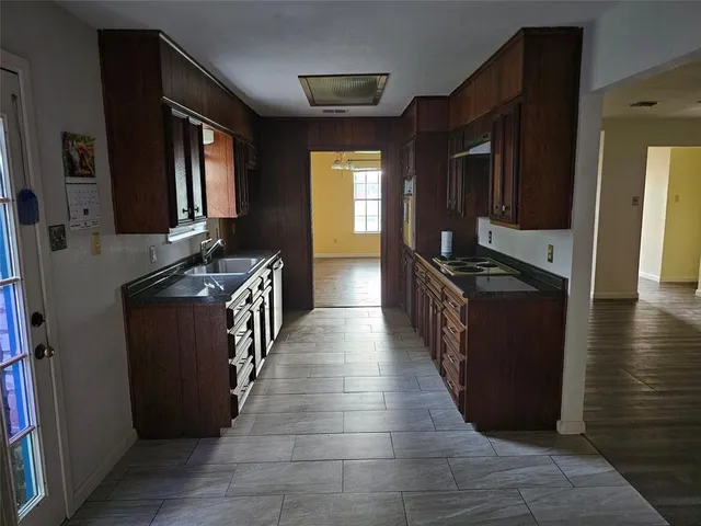 a kitchen with granite countertop a stove and a refrigerator