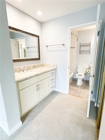 a view of a hallway with bathroom and bathroom