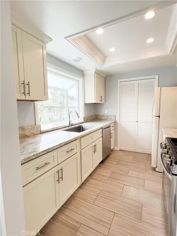 a kitchen with a white cabinets and window