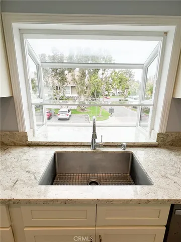 a view of a kitchen island with a tub and large window