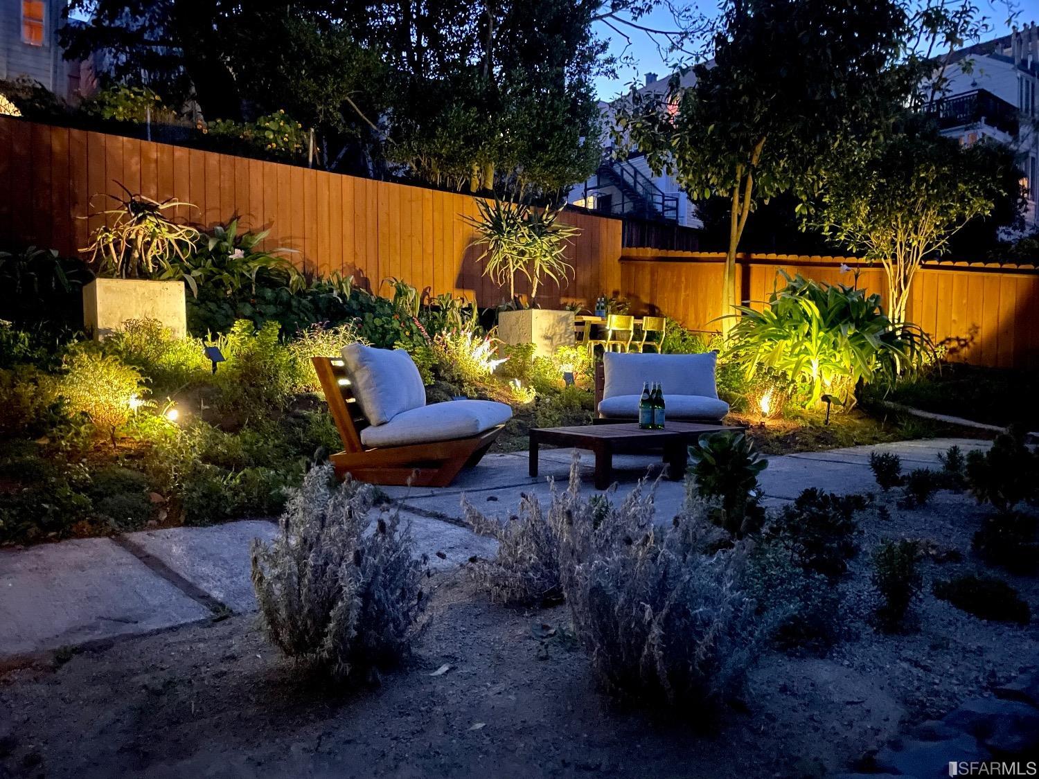 a view of a backyard with plants and a patio