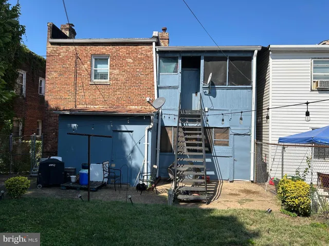 a view of a house with a yard and sitting area