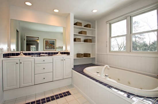 1826 Smith Road Northbrook, IL 60062 - Photo 13 of 22 a bathroom with a granite countertop sink mirror bathtub and next to a window