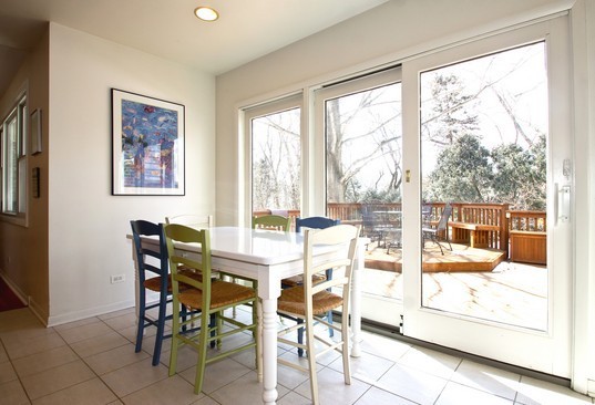 1826 Smith Road Northbrook, IL 60062 - Photo 8 of 22 a view of a dining room with furniture large windows and wooden floor