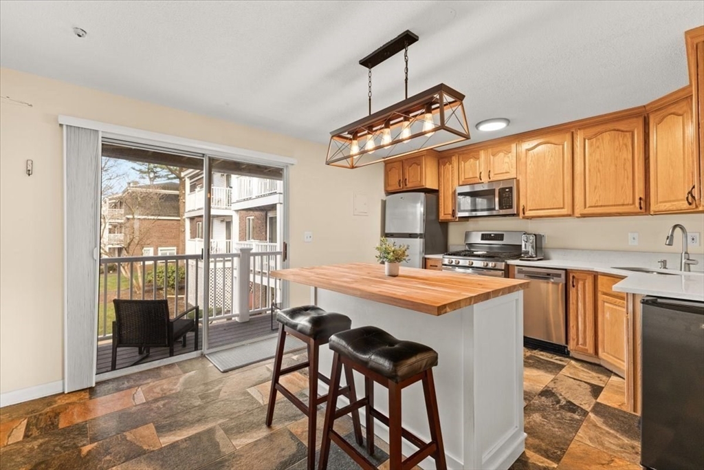 39 Will Drive, Unit 16 Canton, MA 02021 - Photo 3 of 13 a kitchen that has a cabinets and a stove