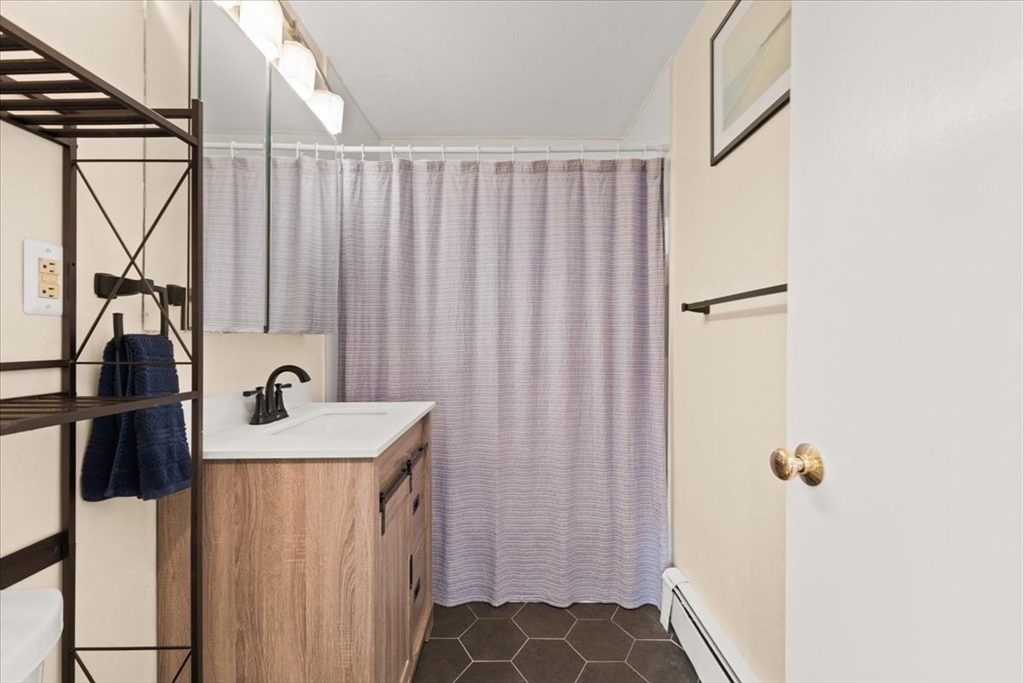 39 Will Drive, Unit 16 Canton, MA 02021 - Photo 8 of 13 a bathroom with a sink and mirror