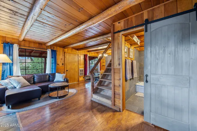 a backyard of a house with wooden floor chairs sofa and barbecue oven