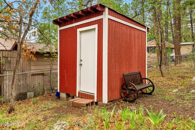 a view of a house with a wooden deck and a yard