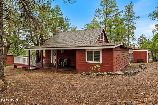 a backyard of a house with barbeque oven table and chairs