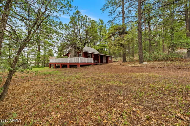 a view of a house with a yard and sitting area