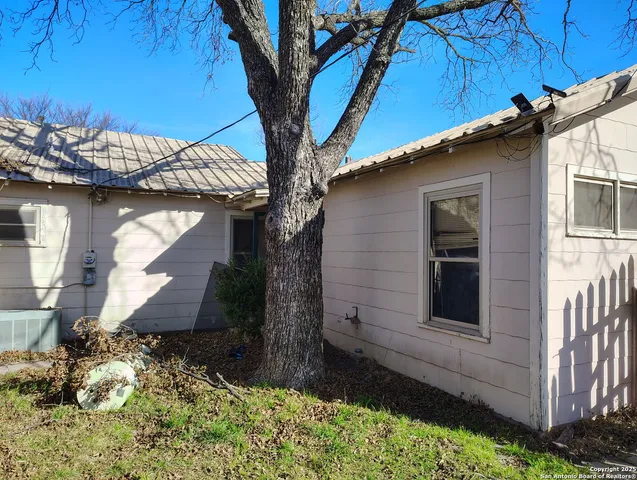 a view of a yard with wooden fence