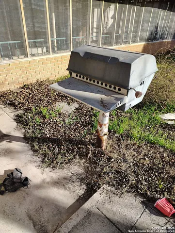 a view of a backyard with wooden fence