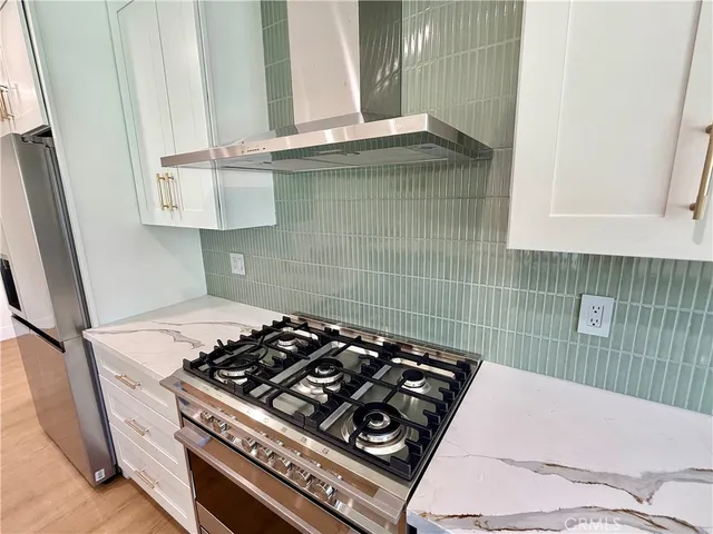 a stove top oven sitting inside of a kitchen