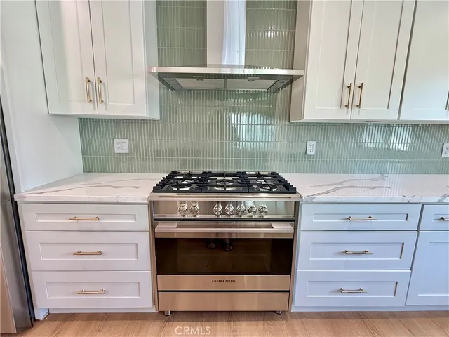 a stove top oven sitting inside of a kitchen and granite counter tops