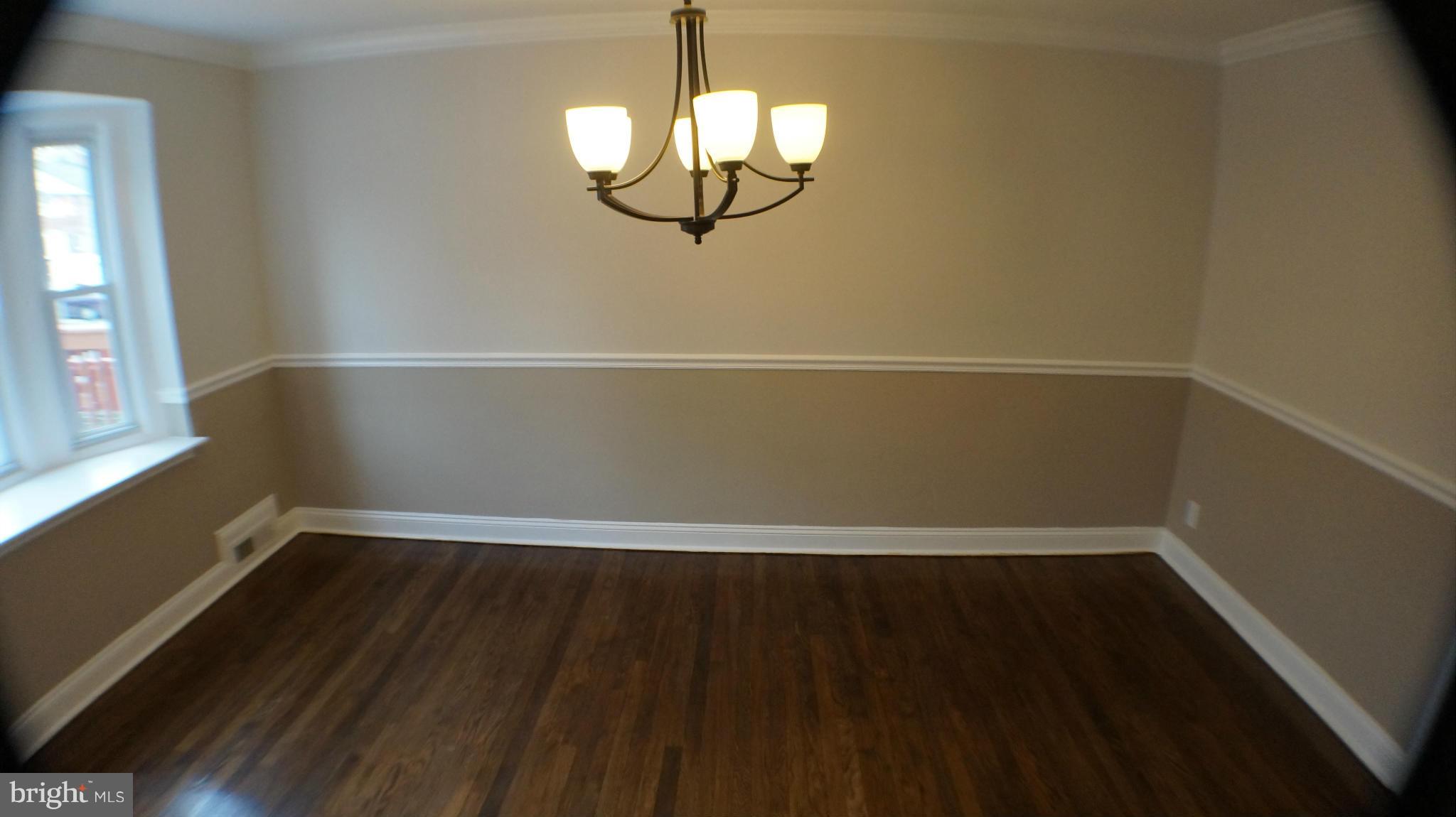 1604 Pentwood Road Baltimore, MD 21239 - Photo 4 of 14 a view of a small space with wooden floor and a window