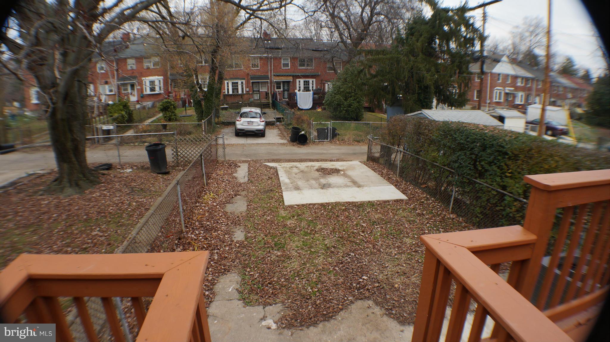 1604 Pentwood Road Baltimore, MD 21239 - Photo 8 of 14 a view of a yard with plants and a table and chairs
