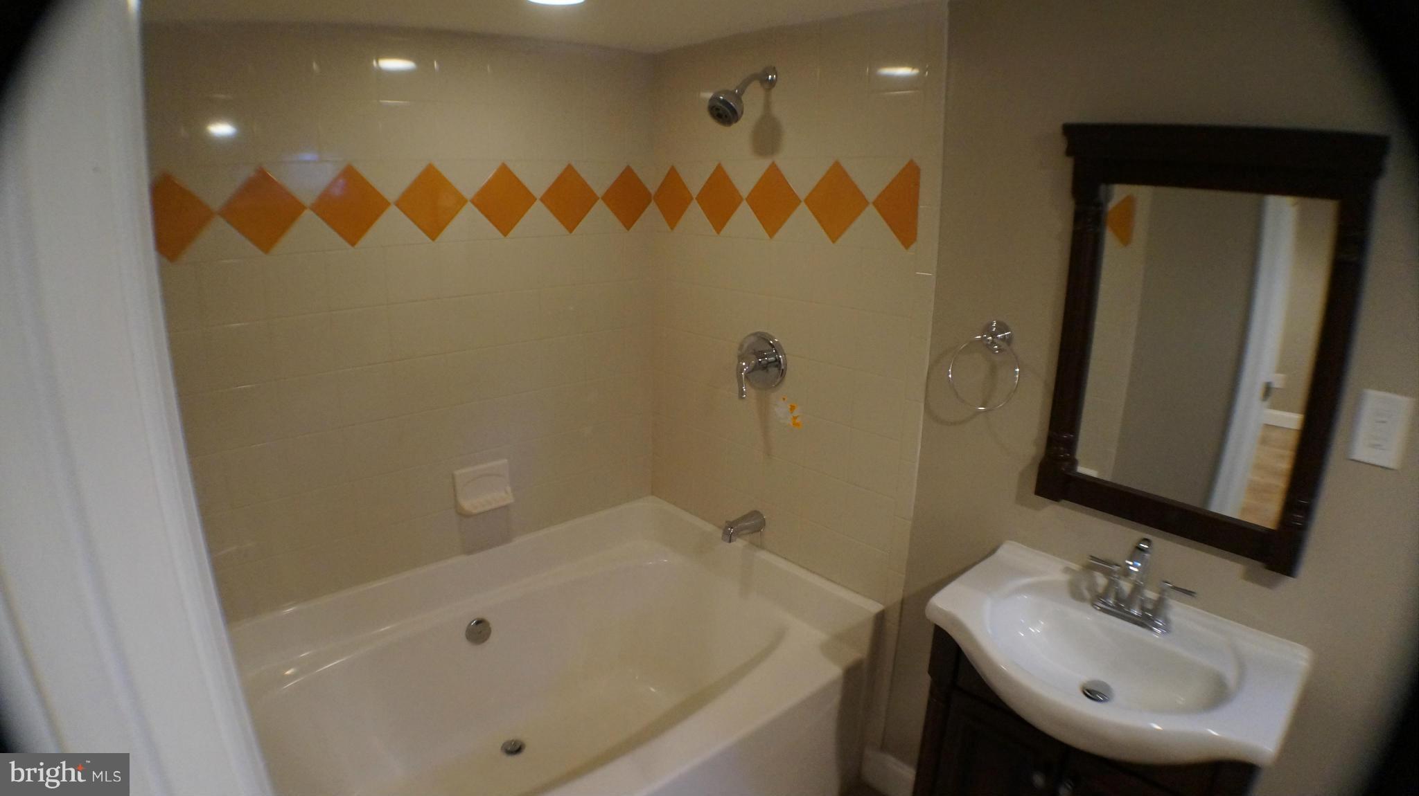 1604 Pentwood Road Baltimore, MD 21239 - Photo 10 of 14 a bathroom with a sink and a tub