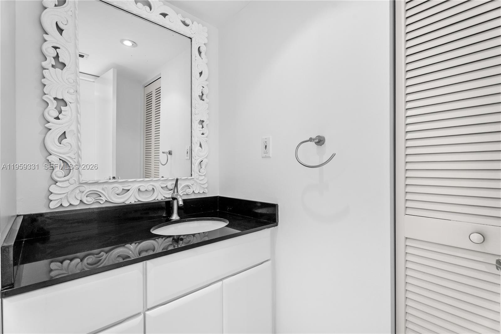 1901 Brickell Avenue, Unit B407 Miami, FL 33129 - Photo 12 of 27 a close view of sink and mirror
