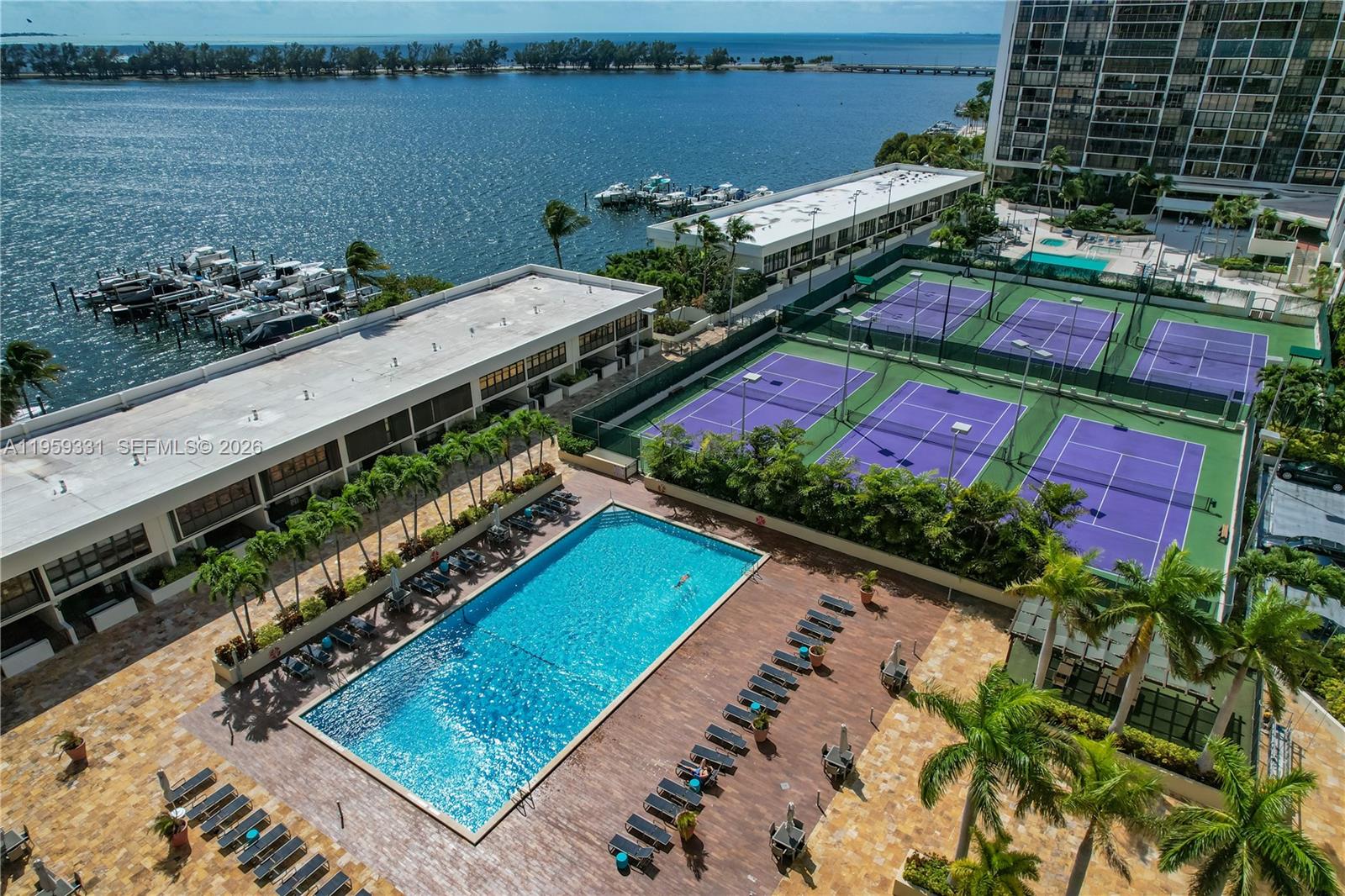 1901 Brickell Avenue, Unit B407 Miami, FL 33129 - Photo 20 of 27 a view of a balcony with chairs and a potted plant