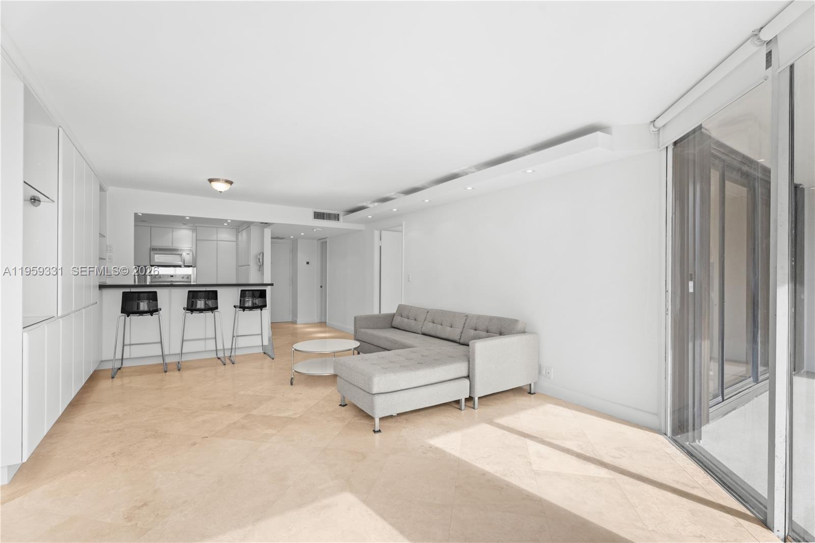 1901 Brickell Avenue, Unit B407 Miami, FL 33129 - Photo 2 of 27 a living room with furniture and a refrigerator