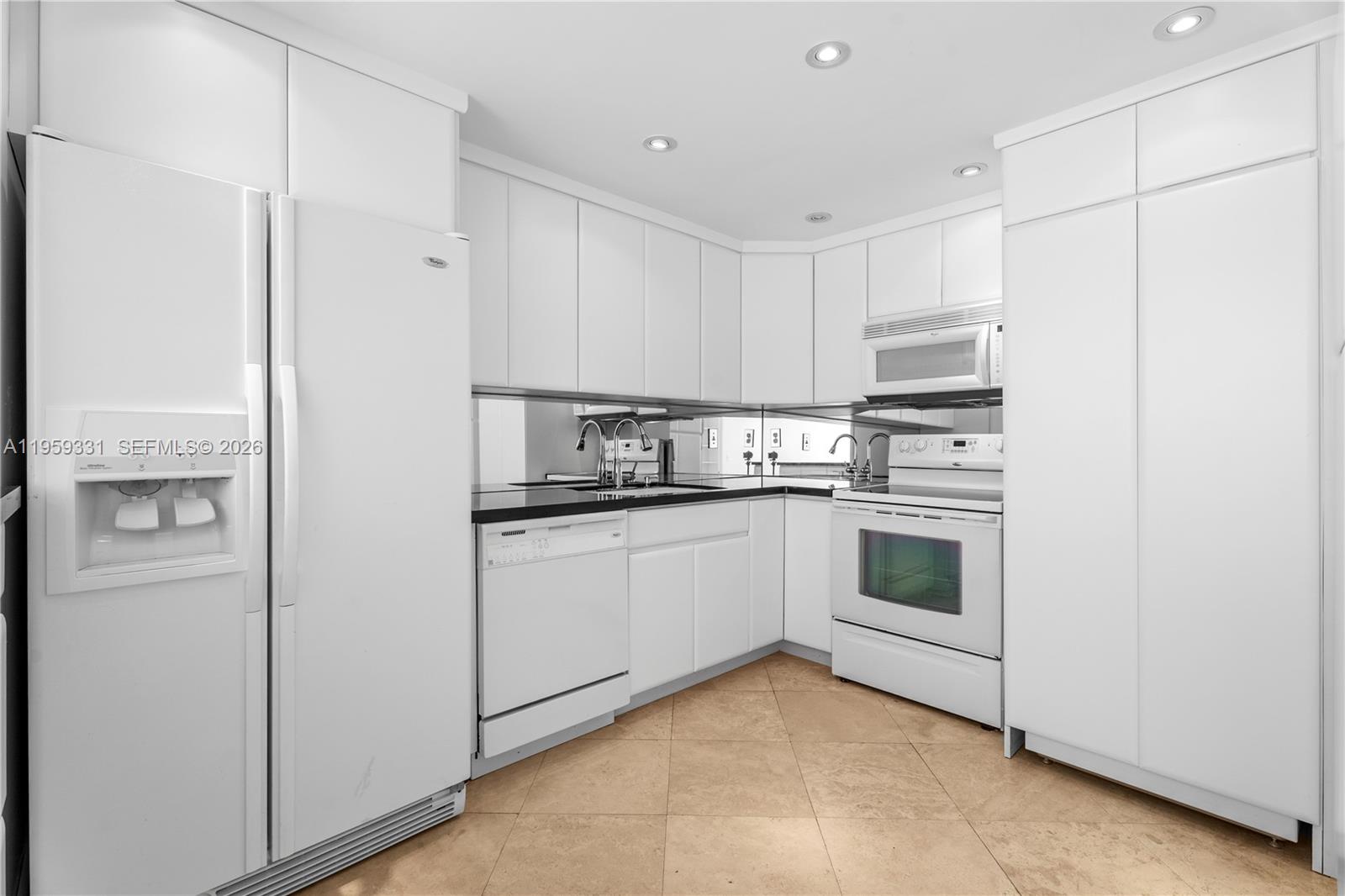 1901 Brickell Avenue, Unit B407 Miami, FL 33129 - Photo 6 of 27 a kitchen with appliances cabinets and a sink