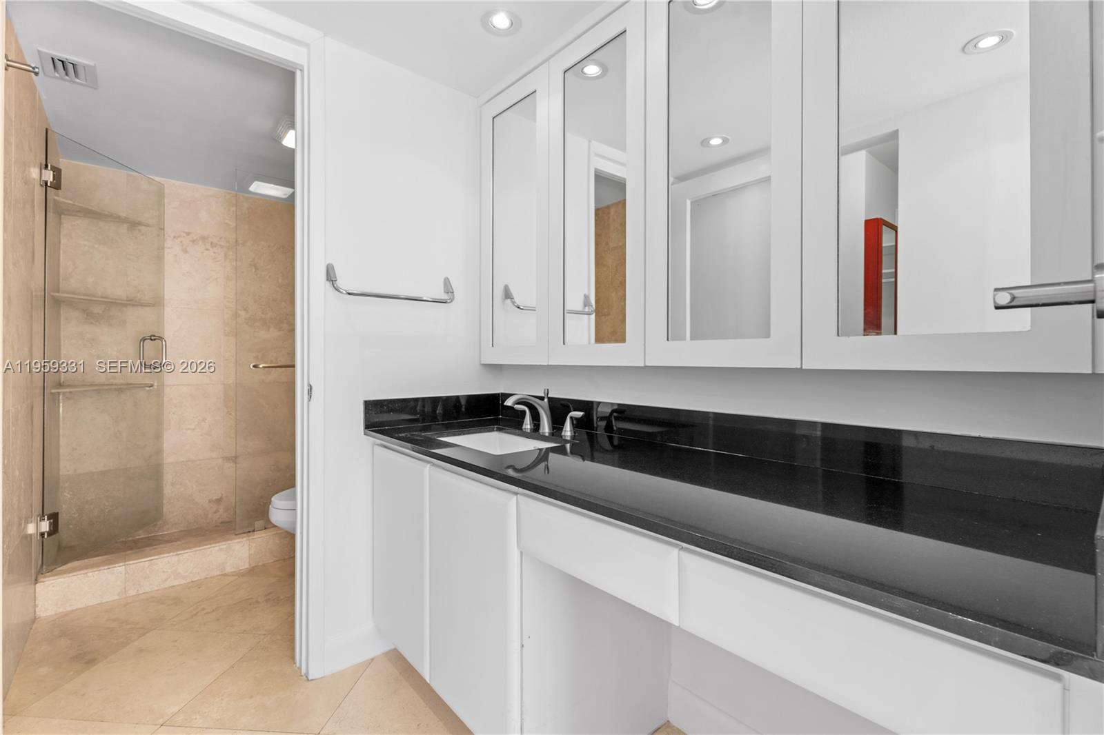 1901 Brickell Avenue, Unit B407 Miami, FL 33129 - Photo 9 of 27 a bathroom with a sink and a mirror