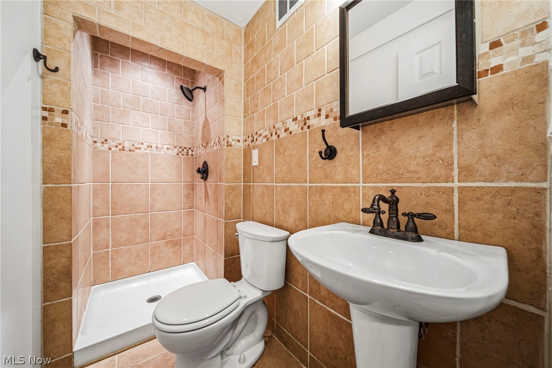 10397 Prouty Road Painesville, OH 44077 - Photo 22 of 32 Bathroom with a stall shower and tile walls