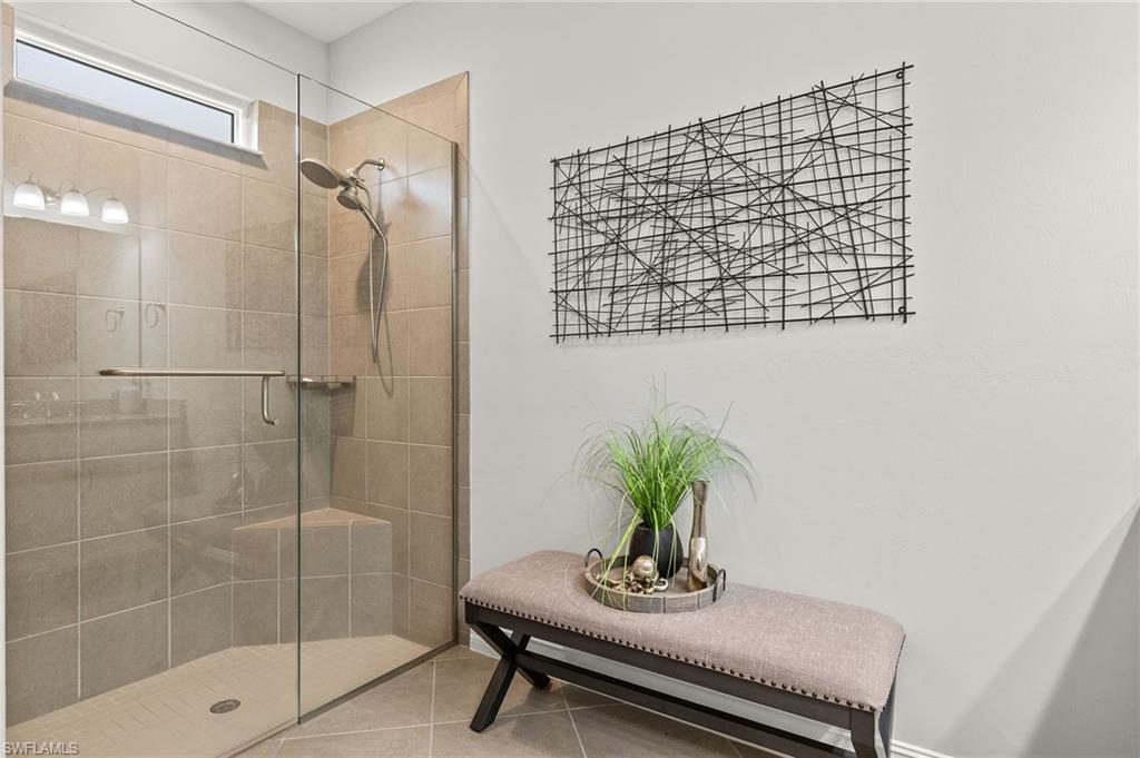 14671 Topsail Drive Naples, FL 34114 - Photo 15 of 36 a bath room with a shower and a sink