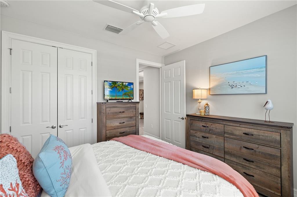 14671 Topsail Drive Naples, FL 34114 - Photo 18 of 36 a bedroom with a bed and a dresser